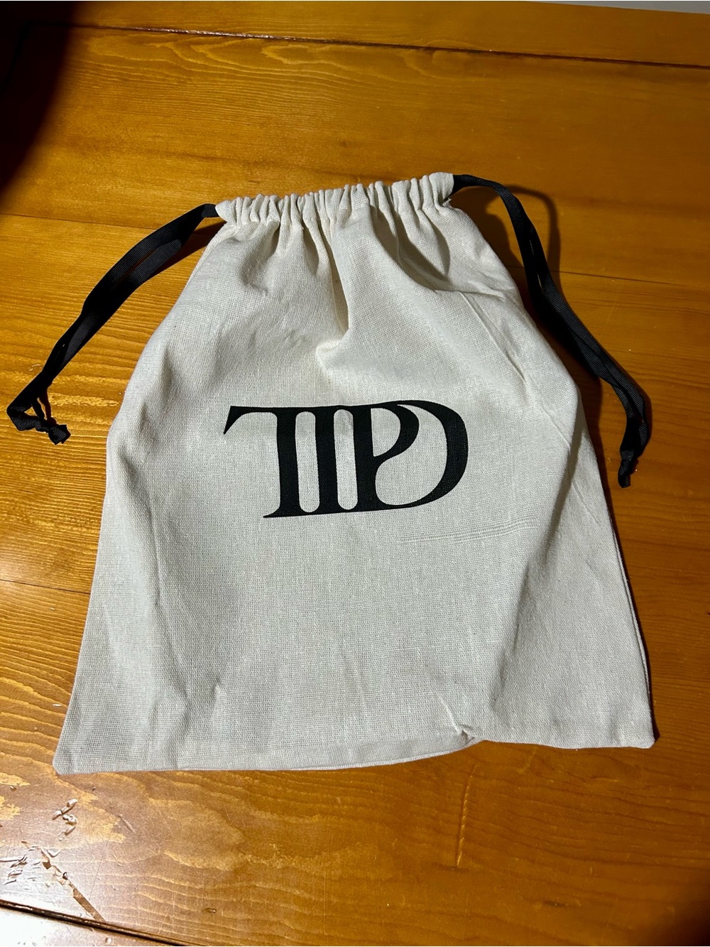 Taylor Swift Cream Drawstring Dust Bag with Black Logo